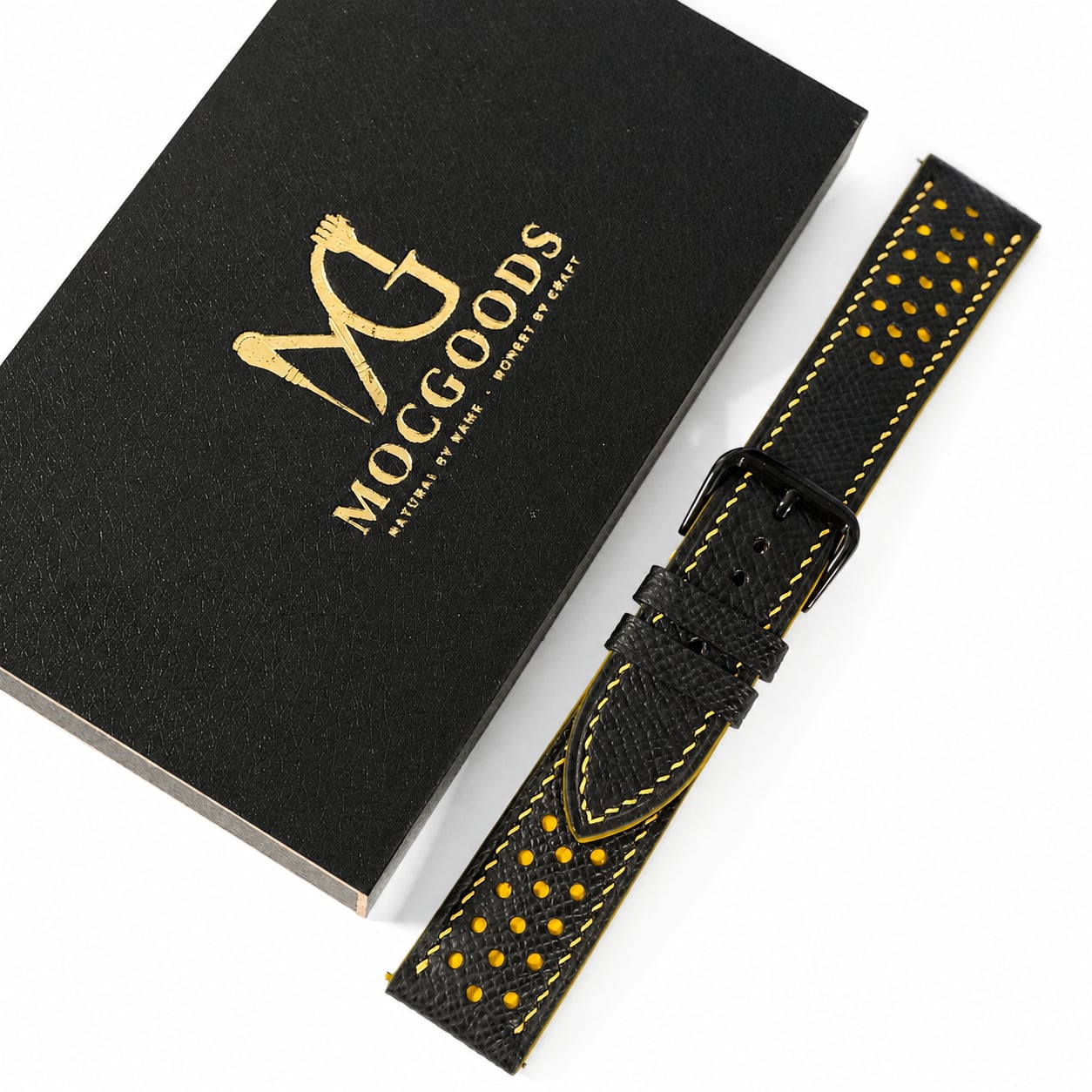 Moc Goods handmade racing watch strap with yellow stitching beside the gold-logo gift box