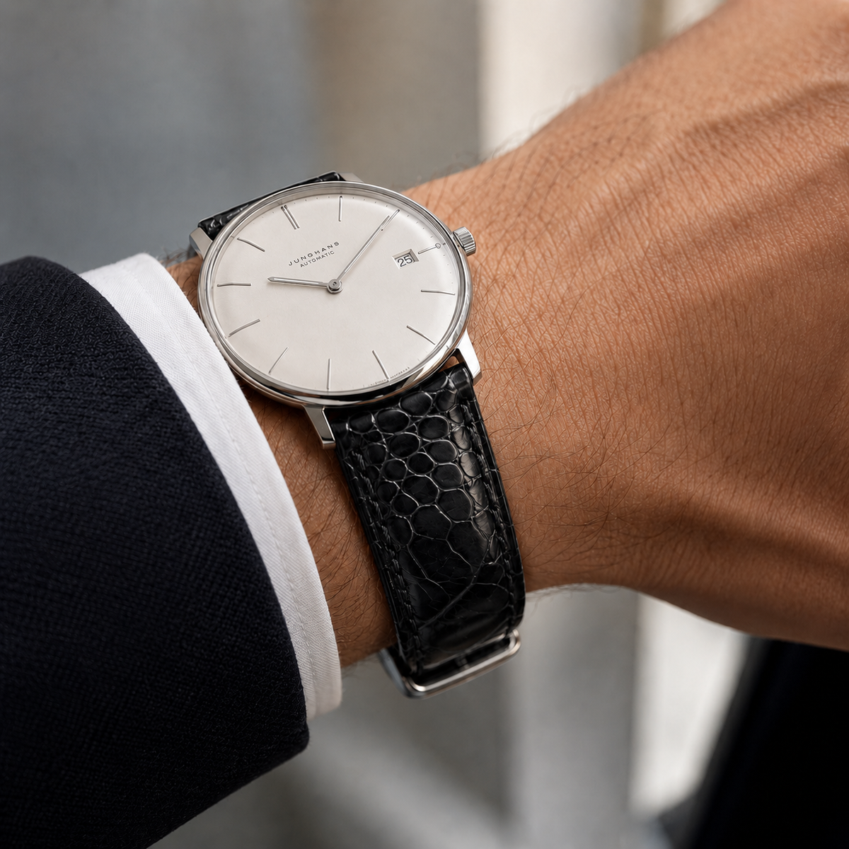Black ostrich leg watch strap worn on the wrist with a dress watch