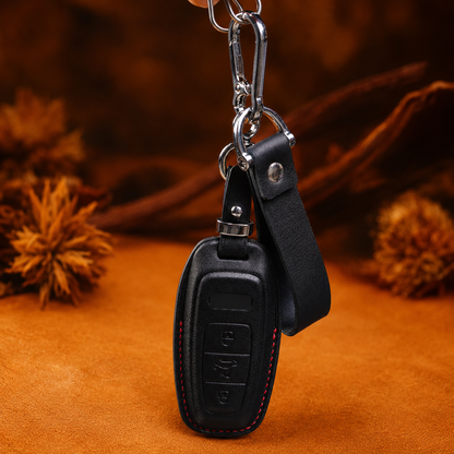 Black leather Audi e-tron key fob cover hanging with keychain strap