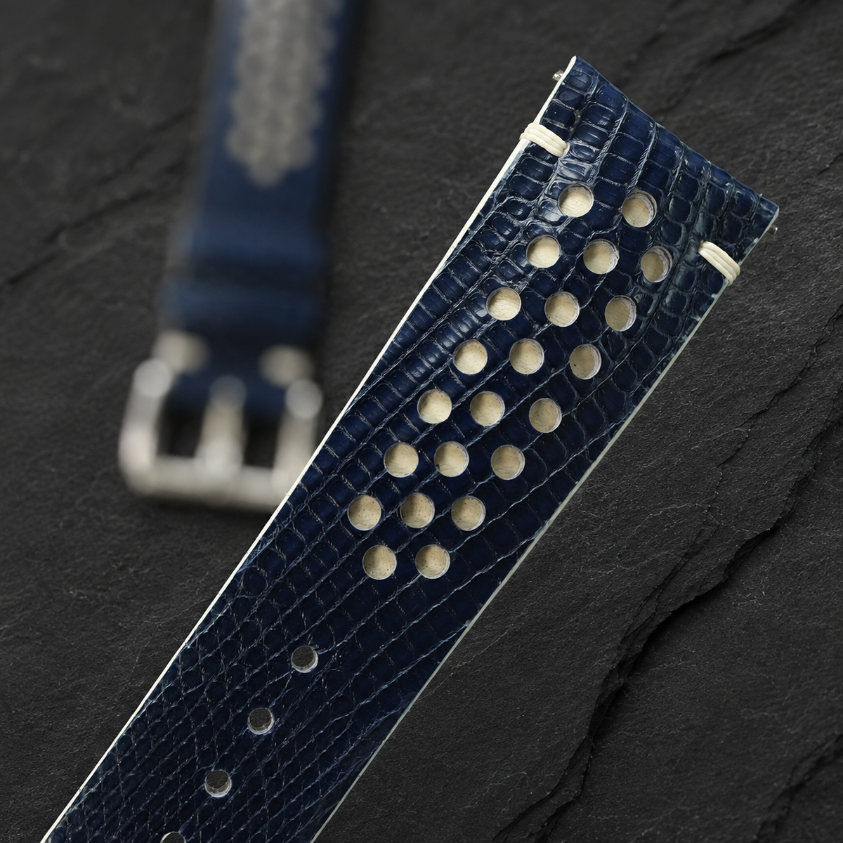 Navy and cream racing rally lizard watch strap, angled close-up of the lizard scale grain