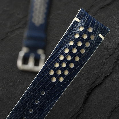 Navy and cream racing rally lizard watch strap, angled close-up of the lizard scale grain