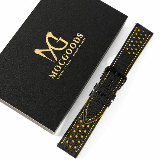 Moc Goods handmade racing watch strap with yellow stitching beside the gold-logo gift box
