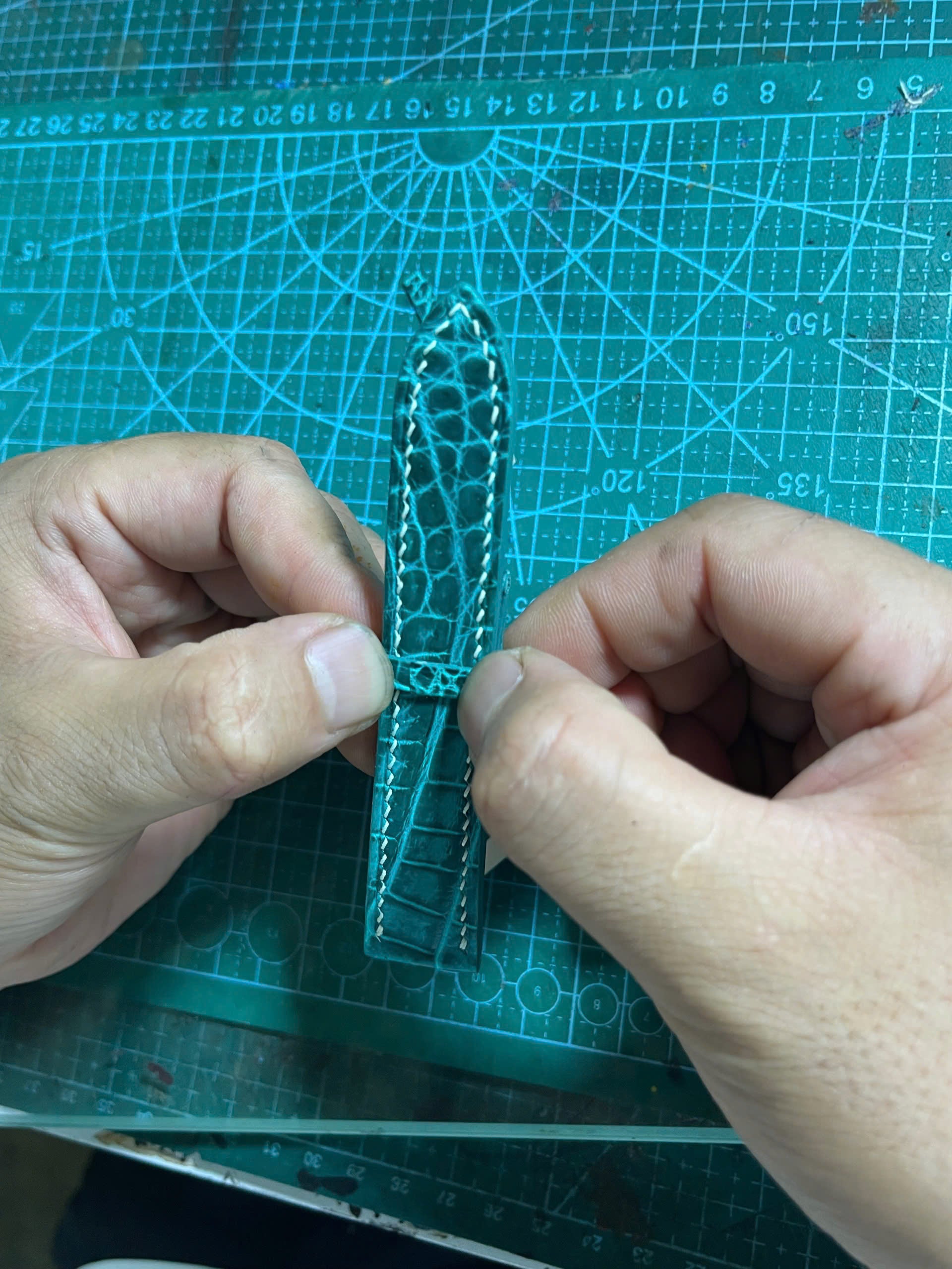 Hand-fitting the keeper loop and securing the buckle on the finished strap